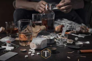 a man with several types of drugs on a table